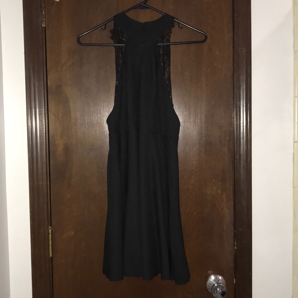 Black mini dress with lace straps.